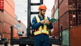 A worker working at container , Man worker managing the import and export container.